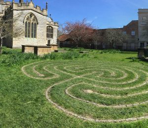 church with labyrinth in the grass - should Christians walk the labyrinth