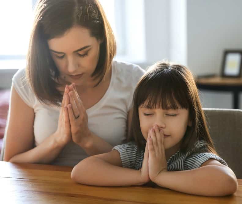 Mom and daughter praying, creating a rhythm of prayer