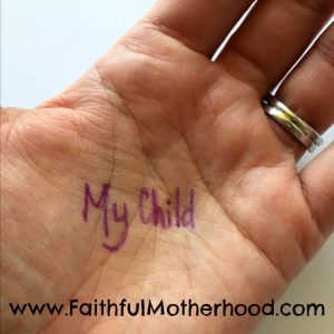 My child written in the palm of a hand