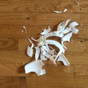 Broken Corelle bowl on wooden floor