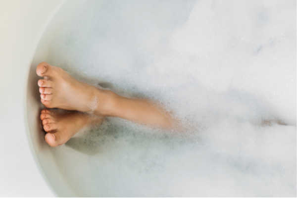 Self-care for Homeschool Moms Mom in bathtub....a white bathtub filled with bubbles.  All we see is a pair of feet sticking out. 