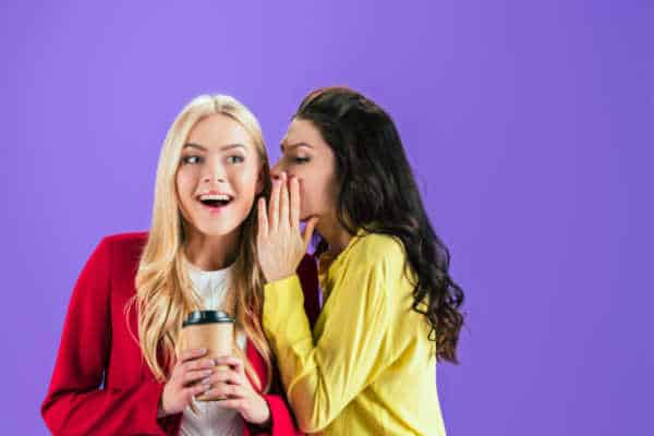 Two women gossiping, purple background