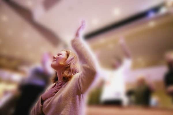Woman with hands lifted in worship