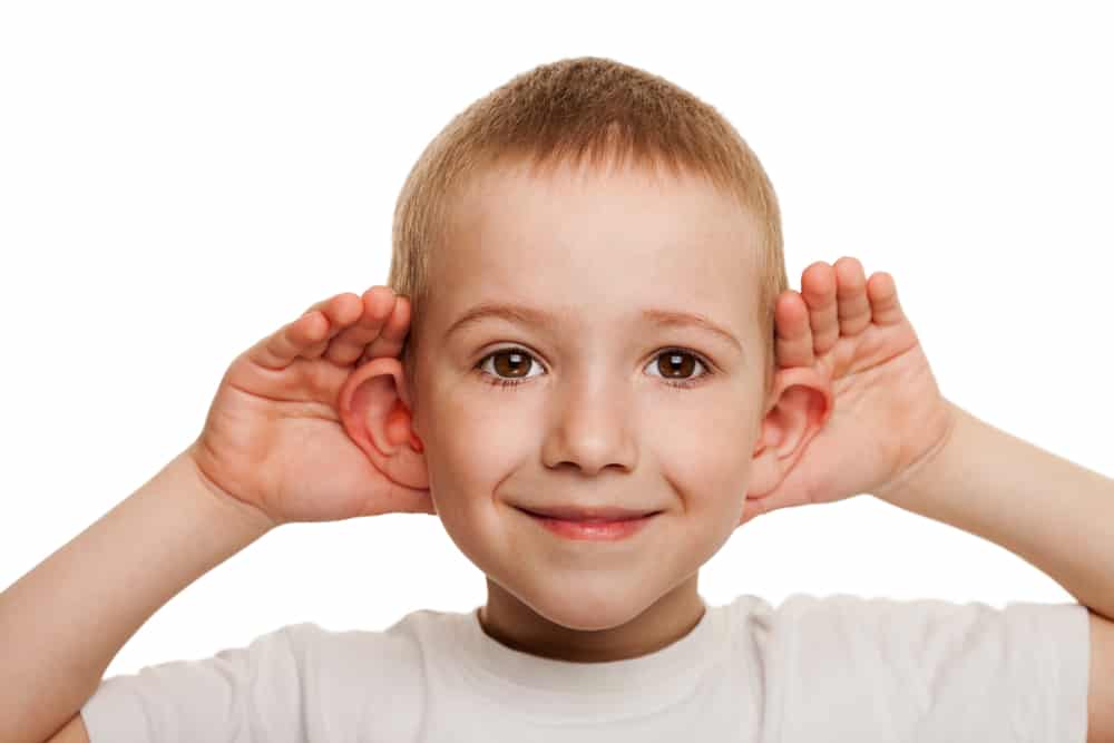 Boy cupping hears - listening to the sermon 