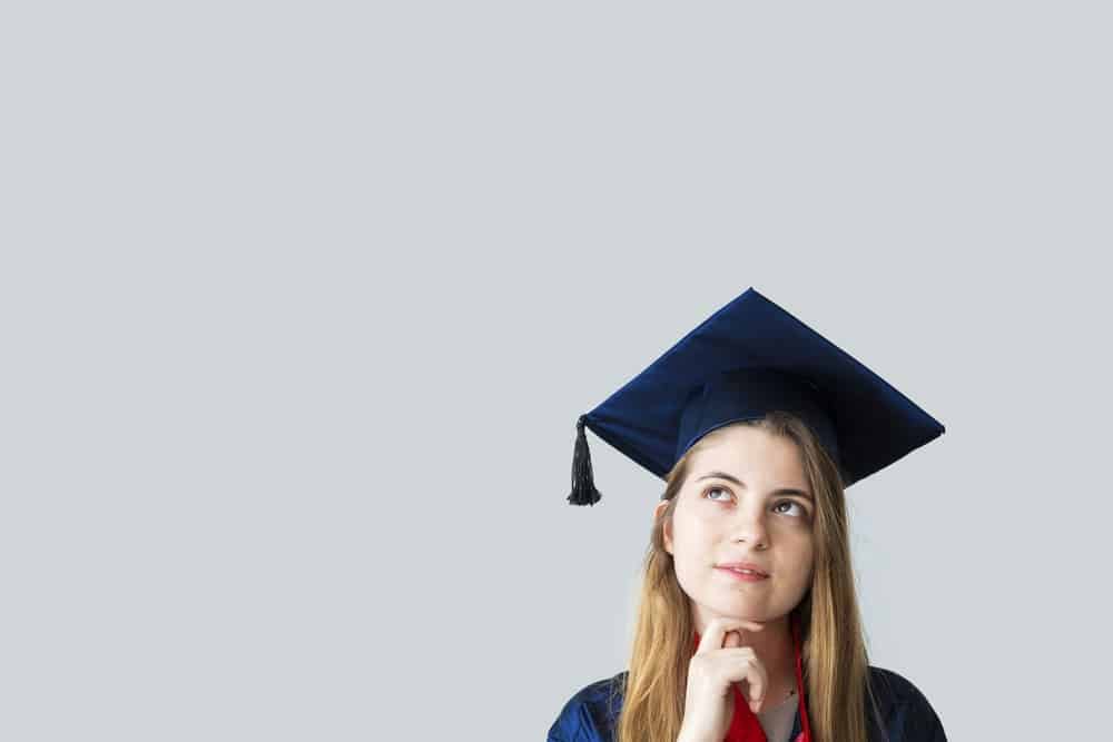 Young woman in a graduation cap, faith in college