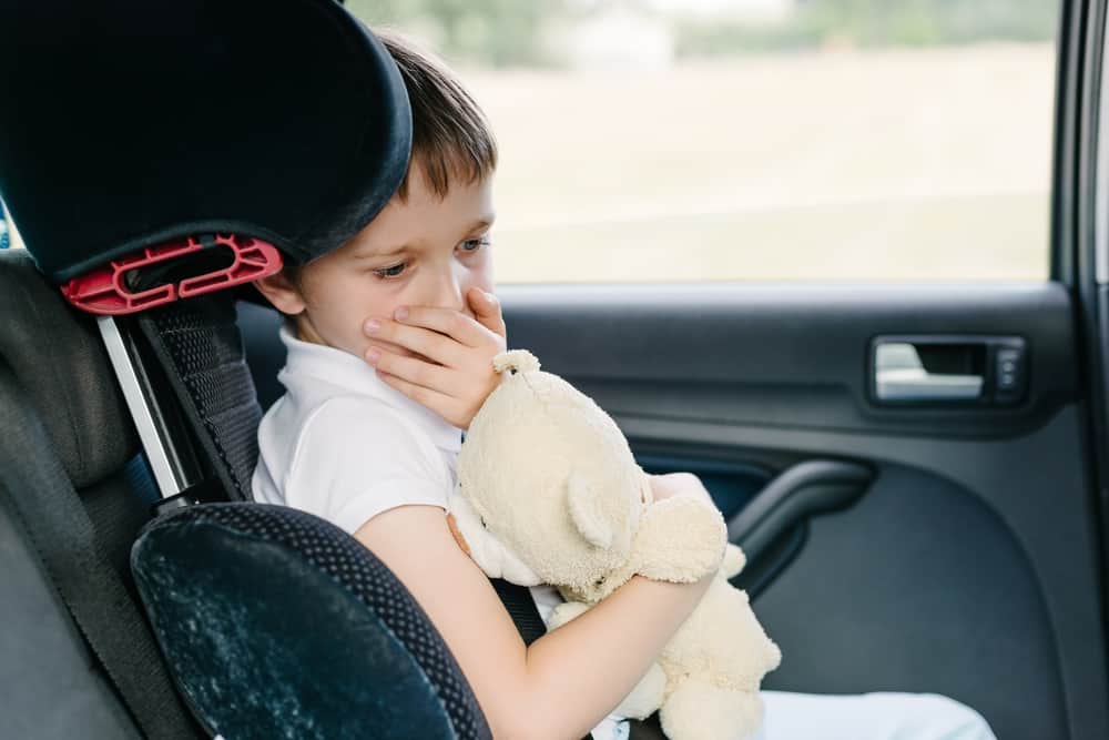 Young boy sick in the car and doesn't feel good. Thankfully due to mom car hacks, his mom has medicine for him. 