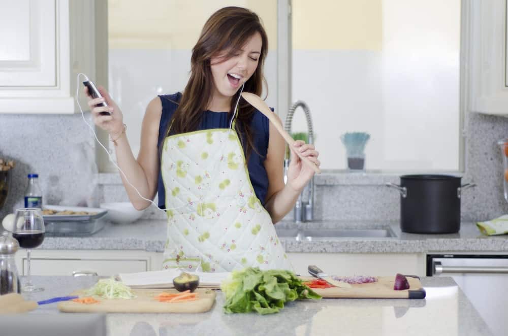 mom combating homeschool burnout by listening to music and singing while cooking dinner