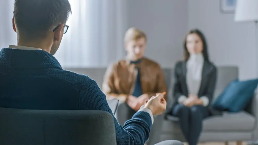 Couple going to Christian marriage counseling in a counselor's office 