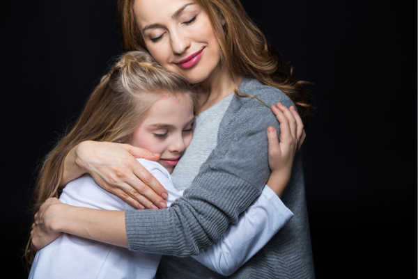 Mom hugging daughter with both smiling - an example of the relationship building needed for discipling