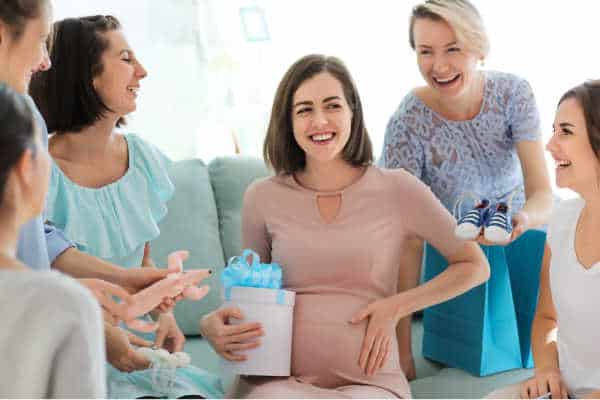 Pregnant woman with her church friends at baby shower party - celebrating each pregnancy can help overcome miscarriage fears