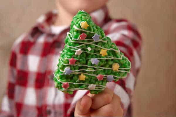 Homeschooling during the holidays can be challenging if your little guy in a plaid shirt is holding up a rice Krispie treat Christmas tree. 