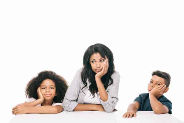 Little girl, Mom, and little boy all with heads in hands and BORED.  African-American mom. All are bored and dislike the children's ministry. 