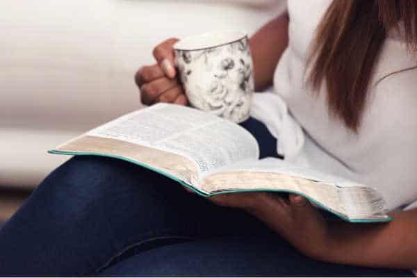 Mom reading her Bible with coffee cup in her hand, she seems like she has all the time in the world and is not wondering how long does my quiet time need to be - very peaceful. 