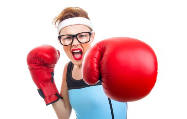 Funny woman with red lipstick, black glasses, and red boxing gloves - she is beating back mom guilt. 