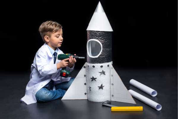 Little boy engineering creating a rocket ship showing entreprenuerial spirit - prepare your homechooler to be an entreprenuer