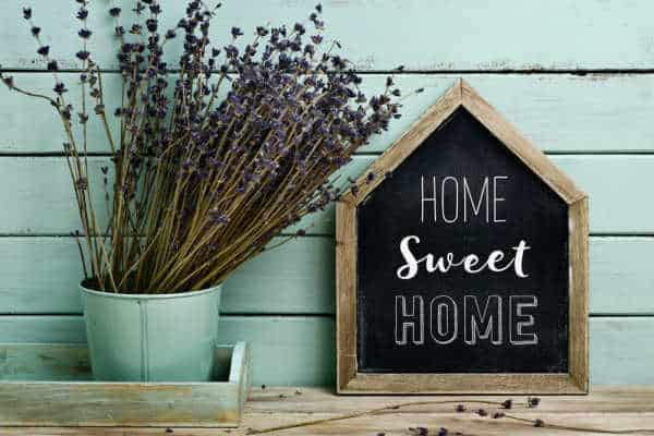 What is a homemaker? A Christian homemaker cultivates a home of welcome like this picture of a can/vase of dried lavender and a house-shaped chalkboard that has Home Sweet Home written on it.  