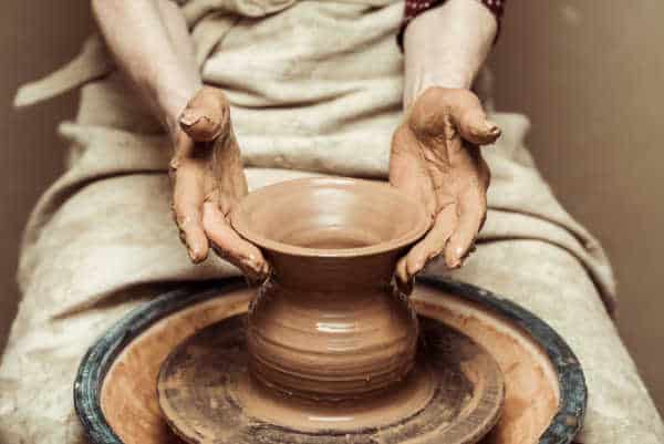 Close up of female hands working on potters wheel just like the making of pottery in the Bible. 