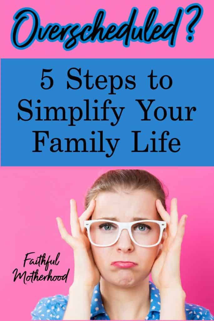 Overscheduled mom holding the sides of her head because she needs to simplify your family schedule.  Blue polka dot blouse, white glasses, hot pink background. 